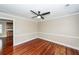 Cozy living room with dark ceiling fan, wood flooring and white trim at 107 Spalding Cir, Goose Creek, SC 29445