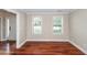 Bright living room with hardwood floors, white trim and natural light from two windows at 107 Spalding Cir, Goose Creek, SC 29445