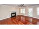 Bright living room featuring hardwood floors, a ceiling fan, and a cozy fireplace at 107 Spalding Cir, Goose Creek, SC 29445