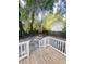 Charming backyard featuring a wood deck overlooking a fenced-in yard with mature trees and a sense of privacy at 107 Tracy St, Walterboro, SC 29488