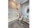 Bathroom featuring a tub, toilet, vanity, with black fixtures and stylish tile flooring at 107 Tracy St, Walterboro, SC 29488
