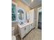 Bright bathroom featuring granite countertops, double sinks, and white cabinets and storage at 107 Tracy St, Walterboro, SC 29488