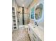 Bright bathroom featuring a glass shower, granite countertops and white cabinets and storage, and mosaic flooring at 107 Tracy St, Walterboro, SC 29488