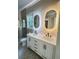 Beautiful bathroom featuring a double vanity with matte black faucets, stone floors and decorative mirrors at 107 Tracy St, Walterboro, SC 29488