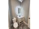 Bathroom vanity with illuminated mirror, sleek black hardware and a tile floor at 107 Tracy St, Walterboro, SC 29488