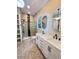 Bright bathroom featuring a glass shower, granite countertops and white cabinets and storage, and mosaic flooring at 107 Tracy St, Walterboro, SC 29488