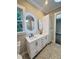 Bright bathroom featuring granite countertops, double sinks, and white cabinets and storage at 107 Tracy St, Walterboro, SC 29488