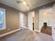 This bedroom features a ceiling fan, gray carpet, and a closet with built-in shelves at 107 Tracy St, Walterboro, SC 29488