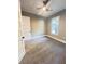 Empty bedroom features neutral walls, gray carpet, ceiling fan and an open door at 107 Tracy St, Walterboro, SC 29488