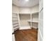 Walk-in closet with custom shelving and hardwood flooring at 107 Tracy St, Walterboro, SC 29488