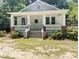 Charming white craftsman-style home with a welcoming front porch and manicured landscaping at 107 Tracy St, Walterboro, SC 29488