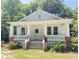 Charming white craftsman-style home with a welcoming front porch and manicured landscaping at 107 Tracy St, Walterboro, SC 29488