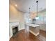 View of the kitchen with island, stainless appliances, custom cabinets, marble countertops, and wood floors at 107 Tracy St, Walterboro, SC 29488