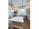 Kitchen view with an island, stainless appliances, a window over the sink, custom cabinets, and marble countertops at 107 Tracy St, Walterboro, SC 29488
