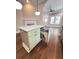 Kitchen island features custom cabinets, marble countertops, and integrated waste receptacles at 107 Tracy St, Walterboro, SC 29488