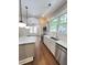 Spacious kitchen with marble countertops, stainless appliances and sunlit archway to living room at 107 Tracy St, Walterboro, SC 29488