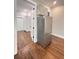 Modern kitchen with stainless steel refrigerator and hardwood floors, complemented by a view into an adjacent room at 107 Tracy St, Walterboro, SC 29488