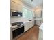 Bright kitchen features stainless steel appliances, custom cabinets, marble countertops, and a window over the sink at 107 Tracy St, Walterboro, SC 29488