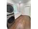 Bright laundry room with front-load washer/dryer, white cabinetry and stone countertop; perfect for efficient living at 107 Tracy St, Walterboro, SC 29488