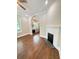 Cozy living room featuring hardwood floors, fireplace and archway to the kitchen at 107 Tracy St, Walterboro, SC 29488