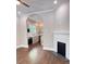 Open-concept living room offers fireplace and archway to the beautifully appointed kitchen at 107 Tracy St, Walterboro, SC 29488