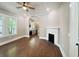 Open-concept living room with hardwood floors, fireplace, and easy access to the kitchen at 107 Tracy St, Walterboro, SC 29488