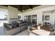 Inviting covered patio with a fireplace, comfortable seating, a dining table and ceiling fan at 11 Tabby Ln, Isle of Palms, SC 29451