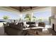 An expansive covered patio boasts a fireplace, comfortable seating, and lovely water views at 11 Tabby Ln, Isle of Palms, SC 29451