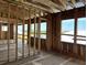 Bright open-concept living room under construction with ample natural light showcasing the space and window placement at 11 Tabby Ln, Isle of Palms, SC 29451