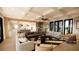 Bright living room boasts modern furnishings, coffered ceiling, and seamless transition to kitchen space at 11 Tabby Ln, Isle of Palms, SC 29451
