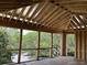 Unfinished patio with wood frame construction and window views of the trees at 11 Tabby Ln, Isle of Palms, SC 29451
