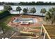 Aerial view featuring a pool under construction, mature trees, and serene waterfront views at 11 Tabby Ln, Isle of Palms, SC 29451