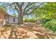 Large, shady backyard with mature trees and a storage shed, offering ample space for outdoor activities at 1143 Winborn Dr, Charleston, SC 29412