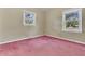 Bedroom featuring two windows, textured wallpaper, and plush pink carpet at 1143 Winborn Dr, Charleston, SC 29412