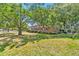 Side view of single-story home featuring brick exterior, red shutters, and mature landscaping at 1143 Winborn Dr, Charleston, SC 29412