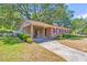 Charming single-story home with a brick facade, a covered carport, and mature landscaping at 1143 Winborn Dr, Charleston, SC 29412
