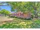 Charming brick home with red shutters and lush landscaping, situated on a well-manicured lawn at 1143 Winborn Dr, Charleston, SC 29412