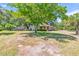 Landscaped front yard featuring mature tree, brick and siding exterior, and long driveway at 1143 Winborn Dr, Charleston, SC 29412