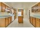 Functional kitchen with wooden cabinets, linoleum flooring, and a convenient center island at 1143 Winborn Dr, Charleston, SC 29412