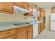 Kitchen featuring wood cabinetry, modern cooktop, and white dishwasher at 1143 Winborn Dr, Charleston, SC 29412