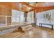 View of the living room featuring wood floors, a brick accent wall, and wooden ceiling at 1143 Winborn Dr, Charleston, SC 29412