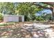 A shed is in the yard of this home with shade trees, foliage, and a gravel area at 1143 Winborn Dr, Charleston, SC 29412