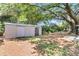 View of a shed with double doors surrounded by mature trees in the backyard at 1143 Winborn Dr, Charleston, SC 29412
