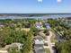 An aerial view of a coastal neighborhood with houses, pond, and trees at 118 Wando Reach Rd, Wando, SC 29492