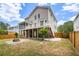 A home's backyard shows a stone fire pit, green grass, and a small garden at 118 Wando Reach Rd, Wando, SC 29492
