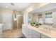 Bright bathroom boasts double vanity, a glass-enclosed shower, and large mirror, offering a clean and modern space at 118 Wando Reach Rd, Wando, SC 29492