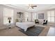 Serene primary bedroom showcasing soft colors, tray ceiling, and well-lit windows for a relaxing atmosphere at 118 Wando Reach Rd, Wando, SC 29492