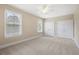 This spacious bedroom features a ceiling fan, neutral walls, carpet, and natural light from two windows at 118 Wando Reach Rd, Wando, SC 29492