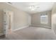 Bright bedroom with neutral walls, carpet, ceiling fan, entry to hallway and entry to bathroom at 118 Wando Reach Rd, Wando, SC 29492