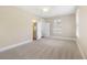 Bright bedroom with neutral walls, carpet, ceiling fan, window, and entry to bathroom at 118 Wando Reach Rd, Wando, SC 29492